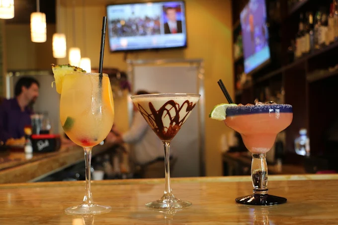 Three cocktails lined up on the bar at San Diego Grill